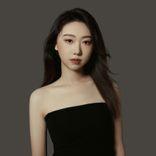 "an overly retouched photo of wantong yao" an asian woman in a black dress looking at the camera